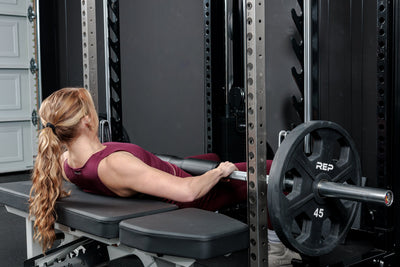 Athlete using the REP Fitness Altitude™ Power Rack Smith Machine Attachment for hip thrusters